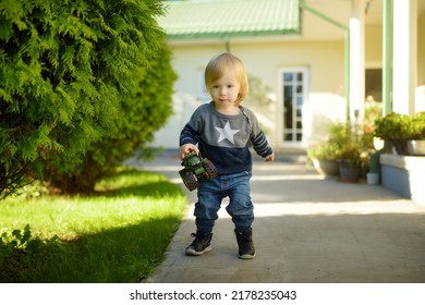 Funny Toddler Boy Having Fun Outdoors On Sunny Summer Day. Child Exploring Nature. Summer Activities For Small Kids.