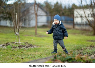 Funny Toddler Boy Having Fun Outdoors On Chilly Winter Day. Child Exploring Nature. Winter Activities For Small Kids.