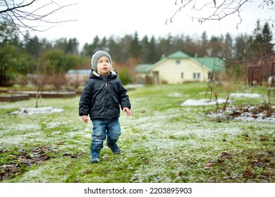 Funny Toddler Boy Having Fun Outdoors On Chilly Winter Day. Child Exploring Nature. Winter Activities For Small Kids.