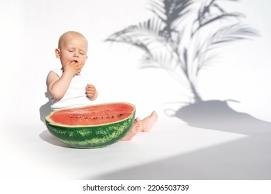 Funny Toddler Boy Playing With Ripe Watermelon, Healthy Fruit Snack On White Background, Hot Summer Day. Organic Vegan Healthy Diet, Feeding, Solid Food Concept. Cute Baby, Child, Kid Emotins.