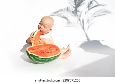 Funny Toddler Boy Playing With Ripe Watermelon, Healthy Fruit Snack On White Background, Hot Summer Day. Organic Vegan Healthy Diet, Feeding, Solid Food Concept. Cute Baby, Child, Kid Emotins.