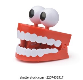 Funny Toy Clockwork Jumping Teeth With Eyes Isolated On White