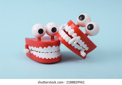 Funny Toys Clockwork Jumping Teeth With Eyes On Blue Background