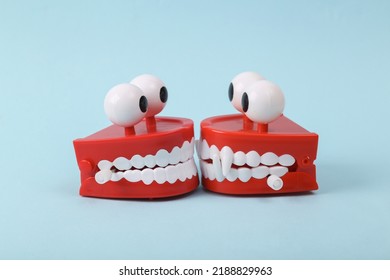 Funny Toys Clockwork Jumping Teeth With Eyes On Blue Background