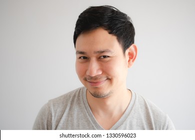 Funny Tricky Awkward Smirk Face Of Asian Man In Grey T-shirt.