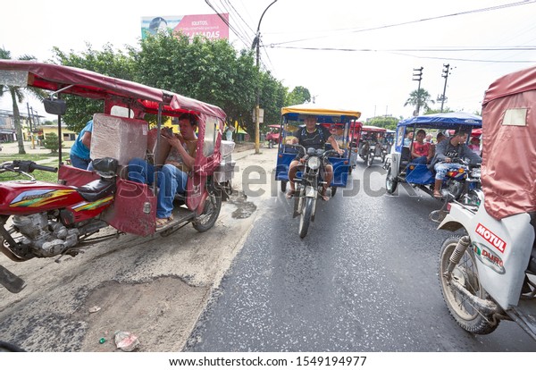 Funny tuk tuk locals transportation race from Peruvian\
amazon airport to points of interest in Iquitos city. Iquitos,\
Peru, Oct, 2019. 