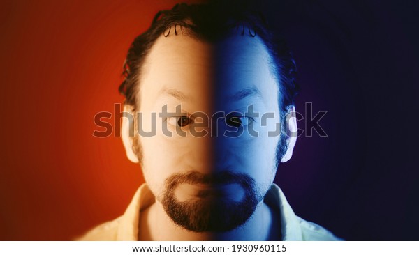 A funny ugly\
man with his eyes crossed, half his face is warm (red), the other\
is cold (blue). Closeup\
shot.\
