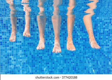 Funny Underwater Family Legs In Swimming Pool, Under Water View Of Mother And Kids, Vacation And Sport Concept
