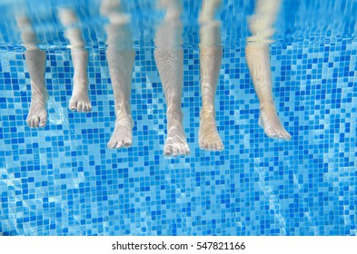 Funny Underwater Family Legs In Swimming Pool, Under Water View Of Mother And Kids, Vacation Fitness Concept
