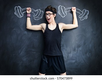 Funny Weak Guy Raises Heavy Dumbbells, Drawn On A Blackboard. Sports And Health Concept. 