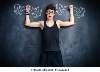 Funny Weak Guy Raises Heavy Dumbbells, Drawn On A Blackboard. Sports And Health Concept. 