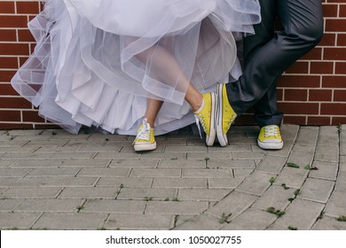 Funny Wedding Couple. Concept Yellow Sneakers And Wedding