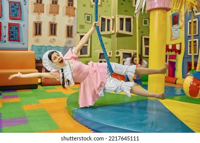 Funny Woman Baby Having Fun On Swing In Playroom