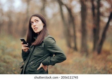 
Funny Woman Checking Her Phone in Autumn Landscape
Young person feeling lost in the woods checking for internet or signal
