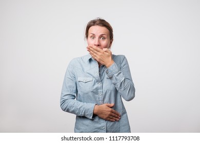 Funny Woman Closing Her Mouth With Palm Hearing Funny Joke. Trying Not To Laugh Loudly