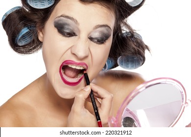 Funny Woman With Curlers And Bad Makeup Applied Lip Pencil