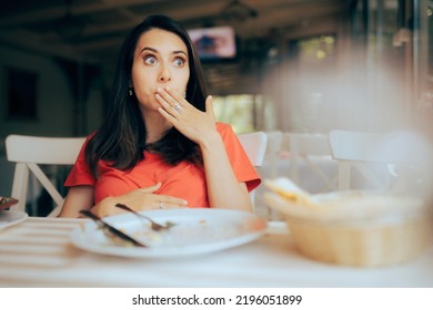 

Funny Woman Feeling Full After Eating A Large Portion Of Food. Restaurant Customer Regretting Overeating Decisions 
