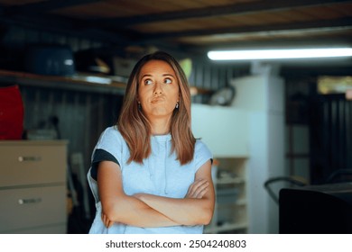 
Funny Woman Feeling Puzzled Standing in a Storage Room. Frustrated millennial girl thinking how to declutter a warehouse space 
 - Powered by Shutterstock