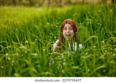 funny woman hiding in tall green grass - Shutterstock ID 2279799697