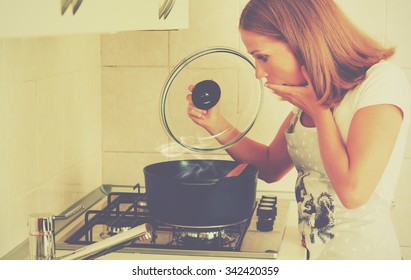 Funny Woman Housewife Prepares In The Kitchen. Burnt Food