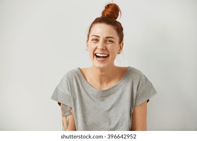 Funny Woman On Grey Background. Cheerful Female Model Joyful. Positive Human Emotion Facial Expression Body Language. 