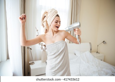 Funny Woman Singing In Hairdryer At Home