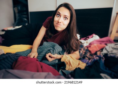 
Funny Woman Sitting On A Pile Of Warn Old Clothes 
Girl Suffering From Compulsive Buying Behavior Hoarding Clothing Items
