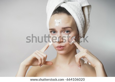 funny woman in a towel on the head happy cleanses the skin with 