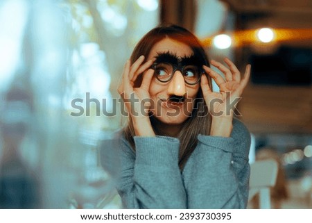 
Funny Woman Wearing Silly Mustache Party Accessories Glasses. Girl with a sense of humor using disguise eyeglasses for a prank
