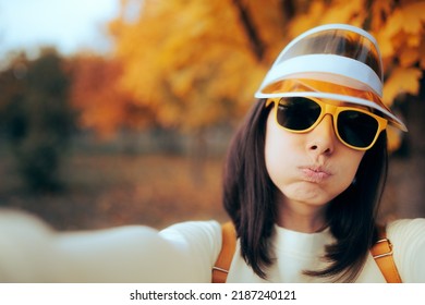 
Funny Woman Wearing Sunglasses And Visor Taking A Selfie Outdoors. Awkward Girl Filming And Taking Pictures On A Trip
