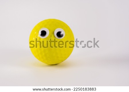 funny yellow ball character with googly eyes isolated on a white background