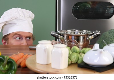 Funny Young Chef Strange Looking At Pot