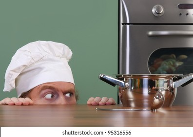 Funny Young Chef Strange Looking At Pot