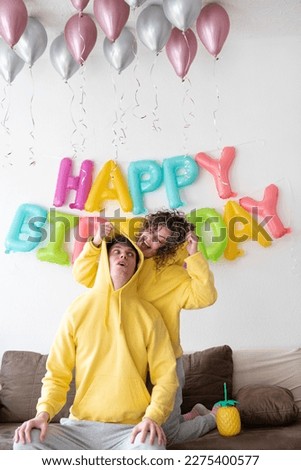 Young couple celebrating a party with their dog