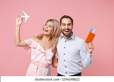 Funny Young Couple Two Guy Girl In Party Outfit Celebrating Posing Isolated On Pink Background. Valentine's Day, Women's Day Birthday Holiday Concept. Hold Passport, Boarding Pass, Ticket, Air Plane