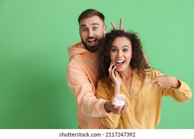 Funny Young Engaged Couple On Color Background