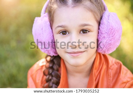 Funny young girl at park. Finish lockdown. Smile person. Schoolgirl portrait. Summer female portrait. Face. Attractive lifestyle. Purple headphones. Street smile. Listen music. Looking at camera