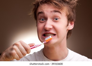 A Funny Young Man Cleans Teeth. Toned.