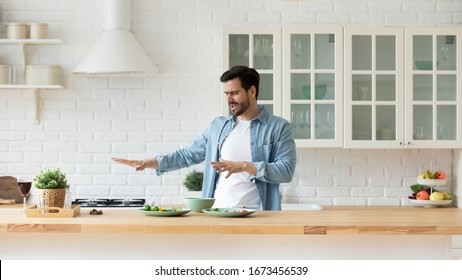 Funny Young Man Dancing In Modern Kitchen, Preparing Healthy Food Alone, Cooking Salad, Carefree Happy Guy Singing And Moving To Favorite Music, Having Fun At Home, Enjoying Leisure Time