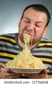 Funny Young Man Eating Pasta