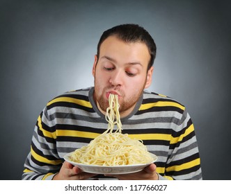 Funny Young Man Eating Pasta