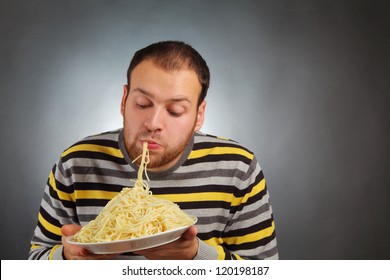 Funny Young Man Eating Pasta