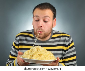 Funny Young Man Eating Pasta