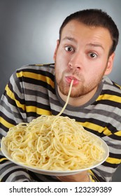 Funny Young Man Eating Pasta