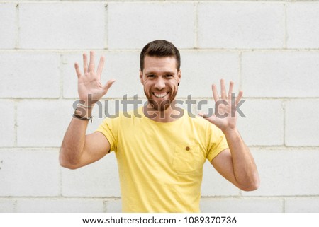 Similar – Image, Stock Photo Funny young man on brick wall with open hands