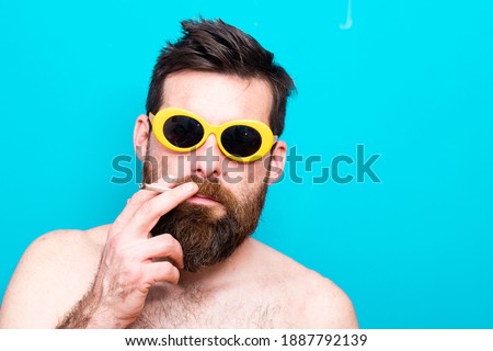 funny young man with sunglasses and cigarette
