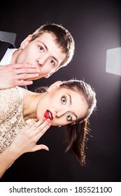 Funny Young Man And Woman Peeking Around The Corner Of Image