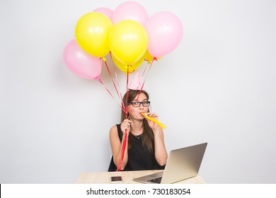 Funny Young Woman Celebrating The Success Of Her Business Or A Birthday In The Office Holding Colorful Party Balloons