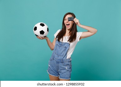 Funny young woman football fan support favorite team with soccer ball covering eye with credit bank card isolated on blue turquoise background. People emotions, sport family leisure lifestyle concept - Shutterstock ID 1298855932