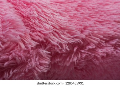 Fur artificial, pink color. Close up. Pile.
